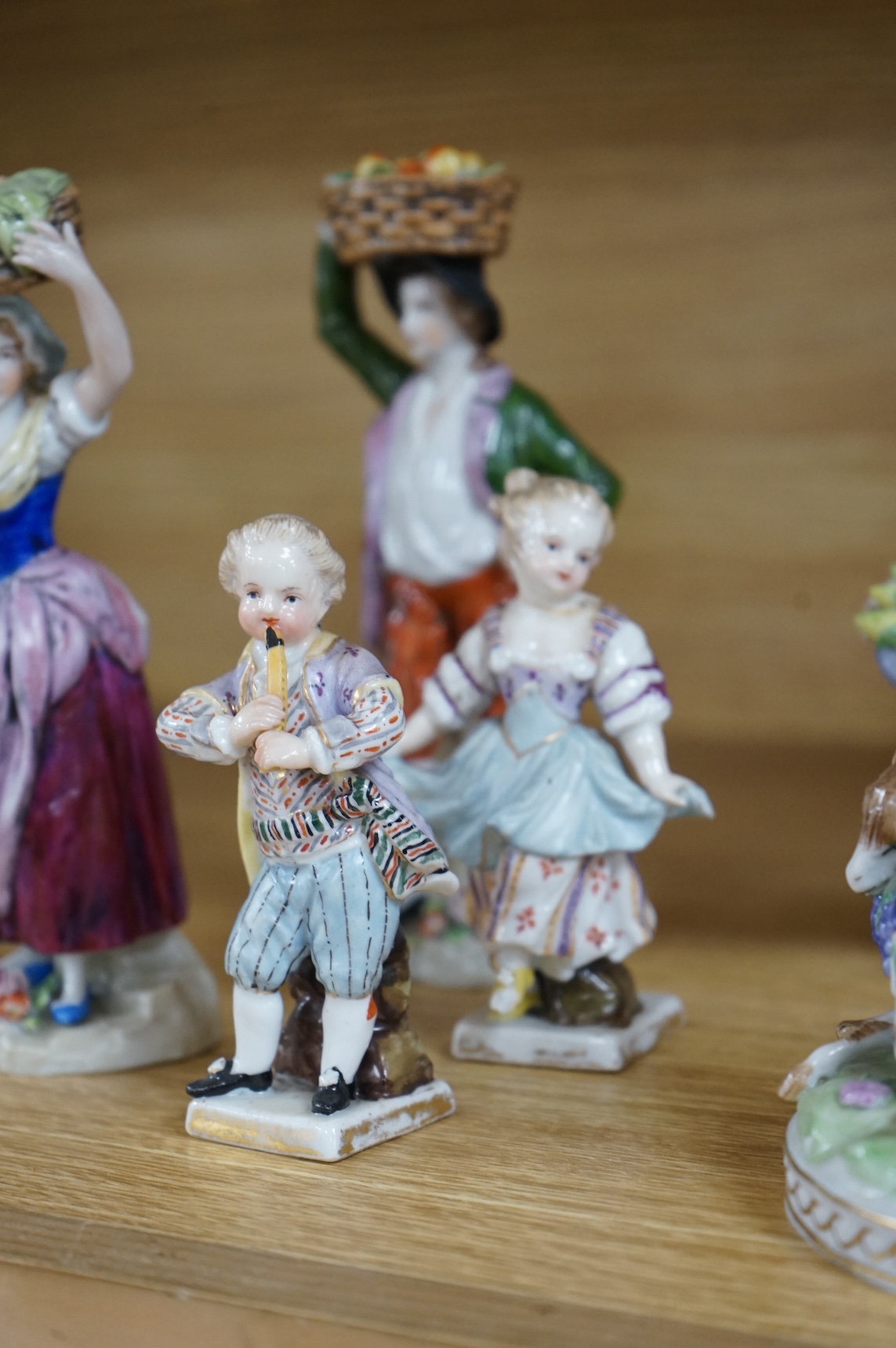 A collection of ten German and English porcelain figures and figure groups, mainly late 19th century, to include Dresden, largest 17cm high